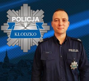 zdjęcie policjanta , na górze logo policji powiatu kłodzkiego, gwiazda policyjna