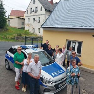 Dzielnicowi prezentują seniorom radiowóz.