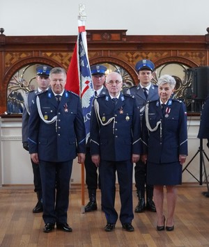 Zdjęcie z uroczystości święta Policji w Sali Domu Pielgrzyma w Wambierzycach, na zdjęciu policjanci i poczet sztandarowy