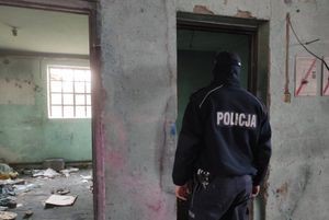 policjant stoi w pomieszczeniu pustostanu